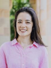 portrait of Dr Annita Stell at the UQ Great Court. She is wearing a pink blouse smiling into the camera.